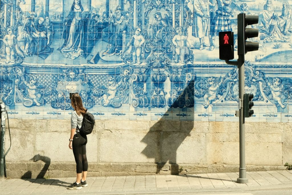 Woman photographing Capela das Almas on Rua de Santa Catarina in Porto