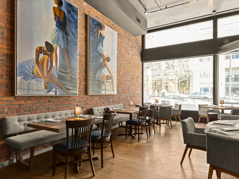 Art-filled dining space at The Alexis Royal Sonesta Hotel Seattle
