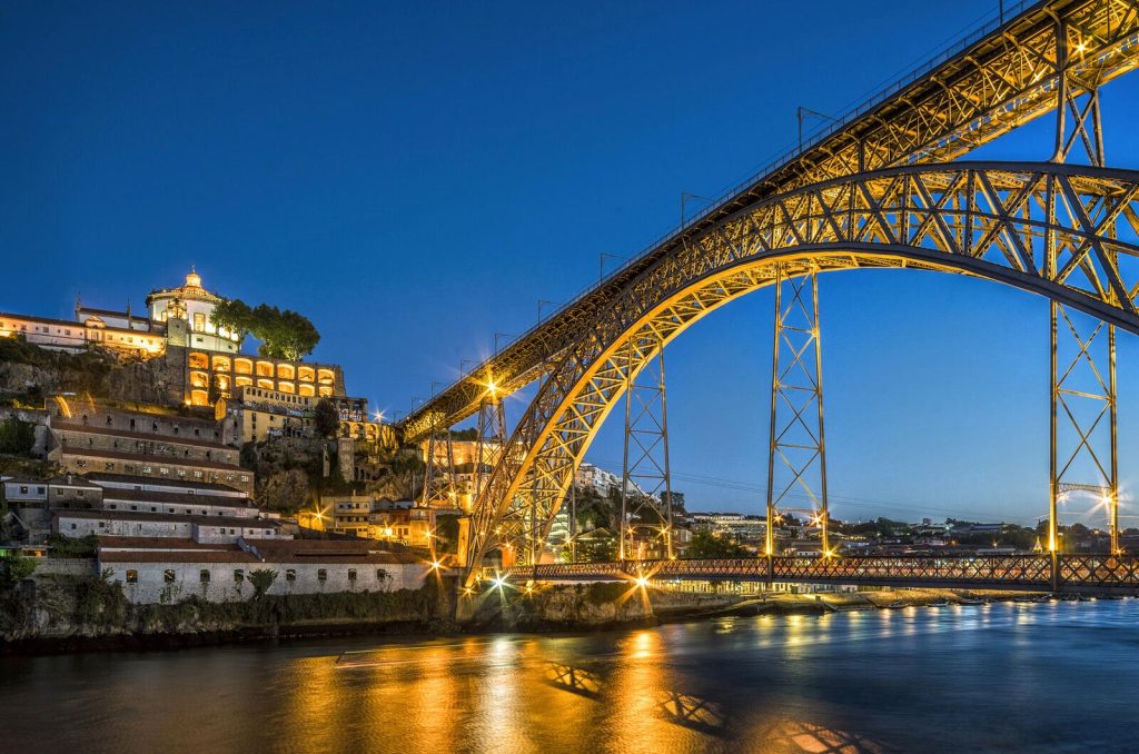 Evening view of Vila Nova de Gaia with Dom Luís I Bridge and Porto skyline