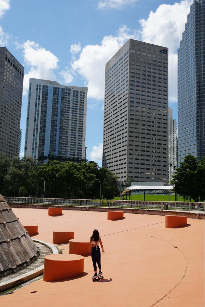 Skateboarder in Bayfront Park with Miami skyline