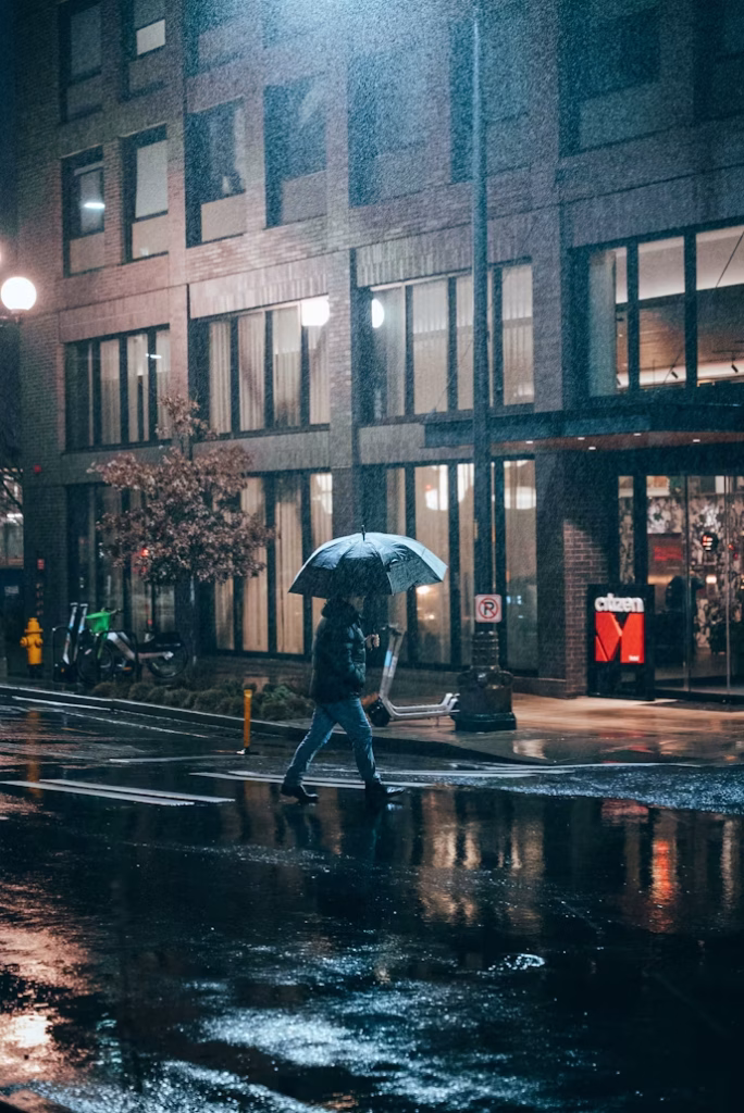 Person walking with umbrella on rainy Seattle street