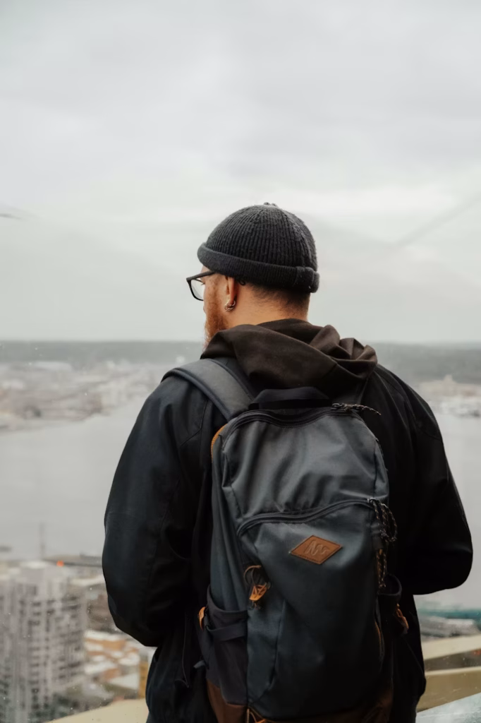 Traveler with backpack overlooking Seattle skyline